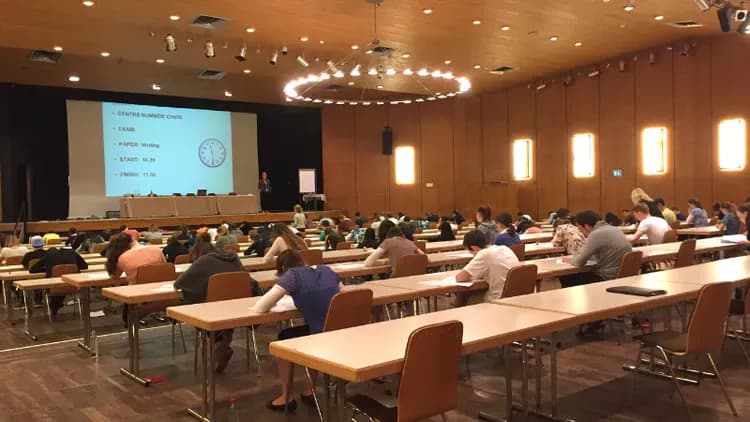 Candidates sitting the exam in a big hall 