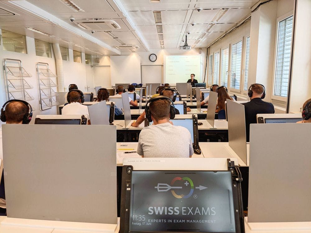 An exam room full with candidates taking their exam on the computer with Swiss Exams. 
