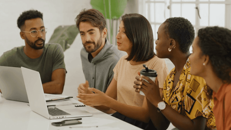 young people discussing some work-related topic, table desk, computer and AI tools