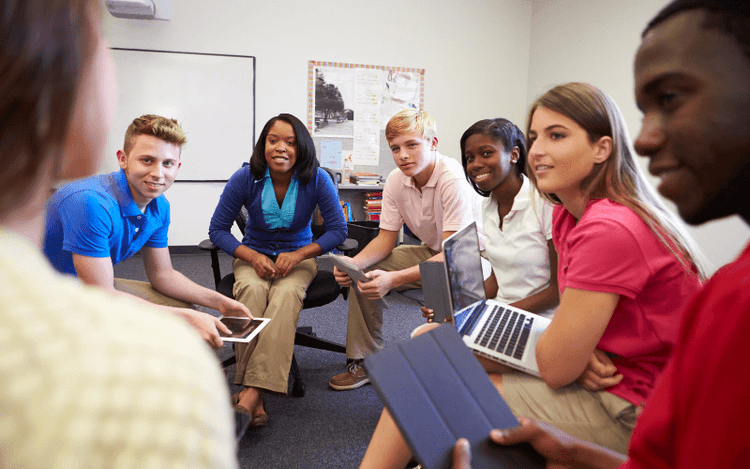 Language students in class debating in circle